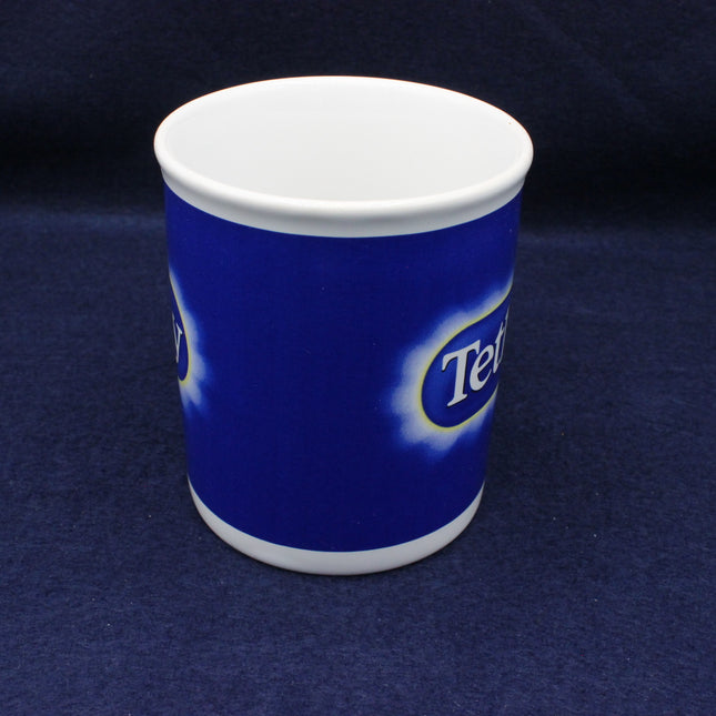 Blue mug with a white lid on a dark blue background
