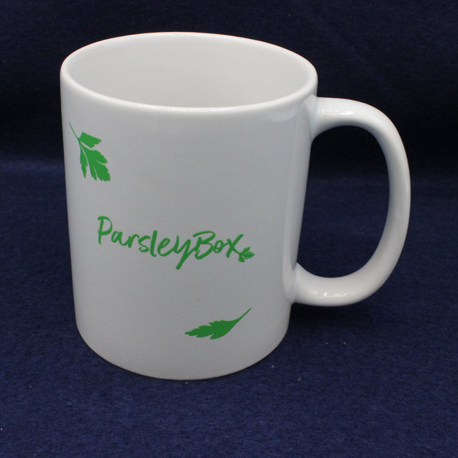White mug with 'ParsleyBox' branding on a dark blue background