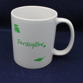 White mug with 'ParsleyBox' branding on a dark blue background
