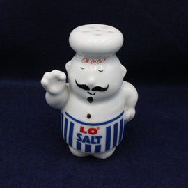 Ceramic salt shaker shaped like a chef with 'LO SALT' on a dark background