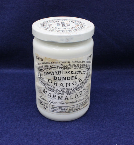 White jar of Dundee Orange Marmalade with a black label on a blue background