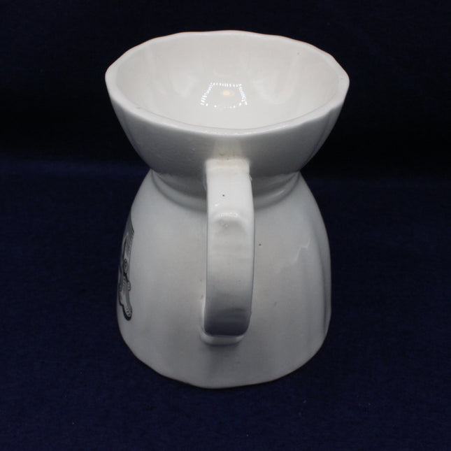 White ceramic pitcher on a dark background