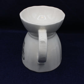 White ceramic pitcher on a dark background