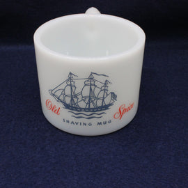 White shaving mug with ship design and 'Old Spice' text on a dark blue background