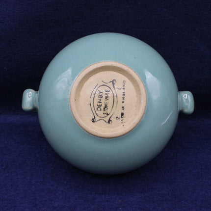 Ceramic vase with a visible brand label on a dark blue background