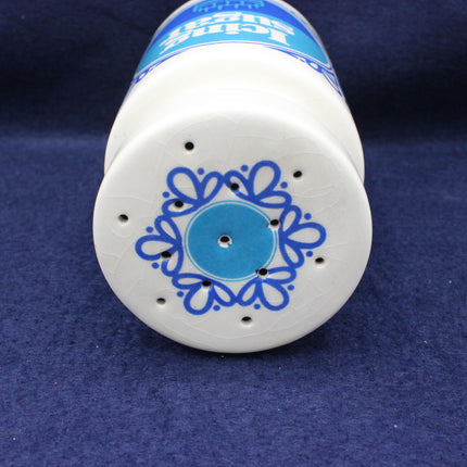 White container with blue decorative design on a blue background