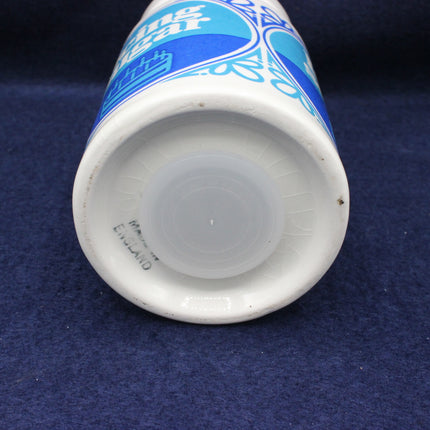 Close-up of a white cup with blue text on a dark blue background