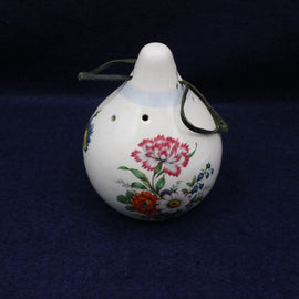 Decorative ceramic scent hanger with floral designs on a dark blue background