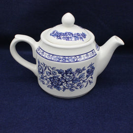 White and blue vintage Sadler Tea Pot on blue background