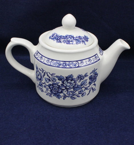 White and blue vintage Sadler Tea Pot on blue background