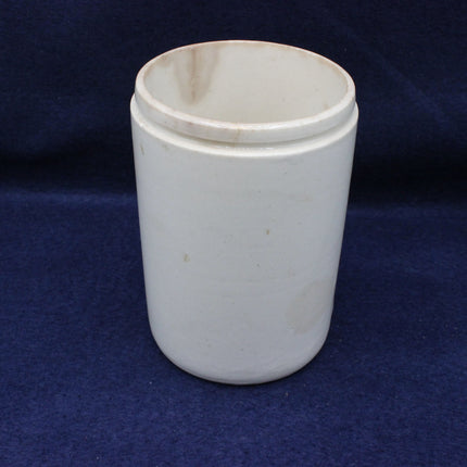 White ceramic cup with a lid on a blue background
