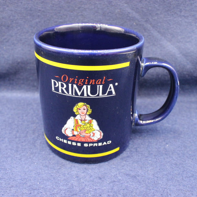 Blue mug with Primula Cheese Spread branding on a blue background