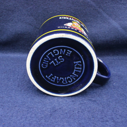 Blue ceramic mug with 'Kiln Craft' branding on a blue background