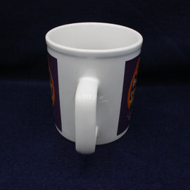 White mug with a logo on a dark blue background