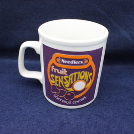 Needlers Fruit Sensation mug on a dark blue background