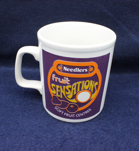 Needlers Fruit Sensation mug on a dark blue background