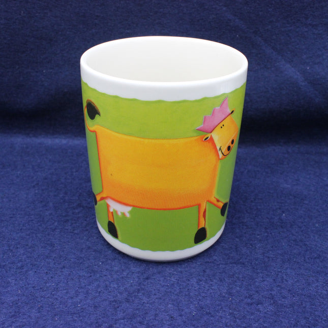 Ceramic cup with a cartoon cow design on a blue background