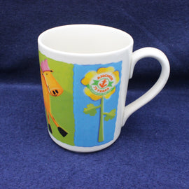 White Anchor Butter mug with colorful design featuring a cow and floral elements on a blue background
