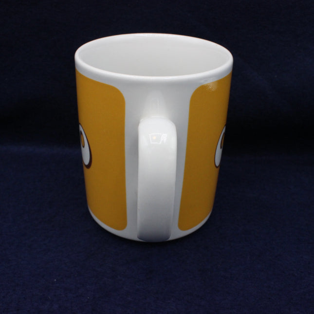 White mug with orange stripes on a dark blue background