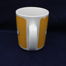 White mug with orange stripes on a dark blue background