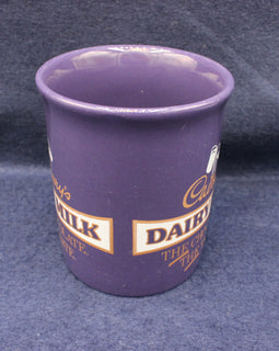Purple cup with Cadbury Dairy Milk branding on a dark blue background