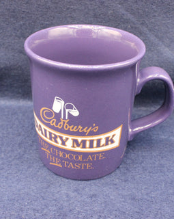 Purple mug with Cadbury's Dairy Milk branding on a gray background