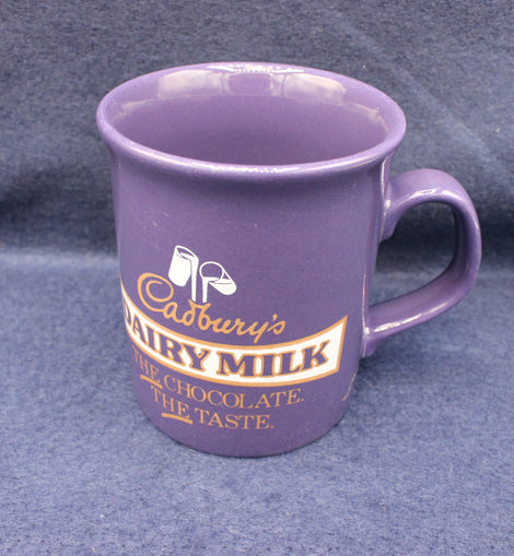 Purple mug with Cadbury's Dairy Milk branding on a gray background