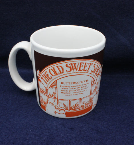 White mug with orange and brown design on a blue background