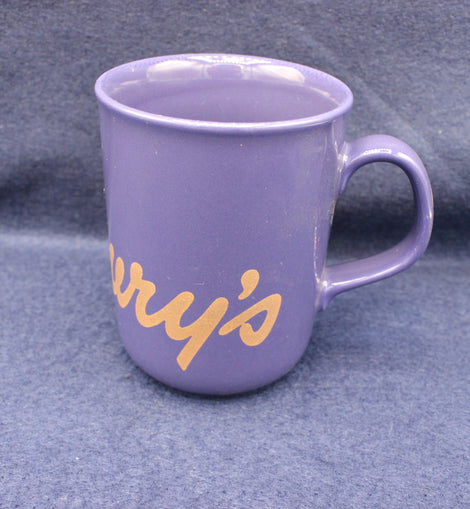 Purple mug with 'Cadbury's' text on a grey background