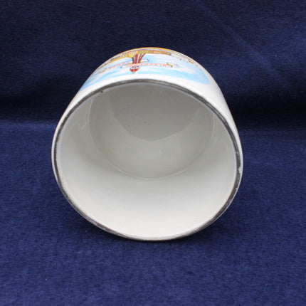 Ceramic cup with decorative interior on a blue fabric background