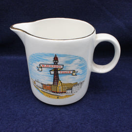 White ceramic creamer with Blackpool Tower design on a blue background
