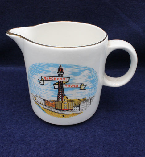 White ceramic creamer with Blackpool Tower design on a blue background