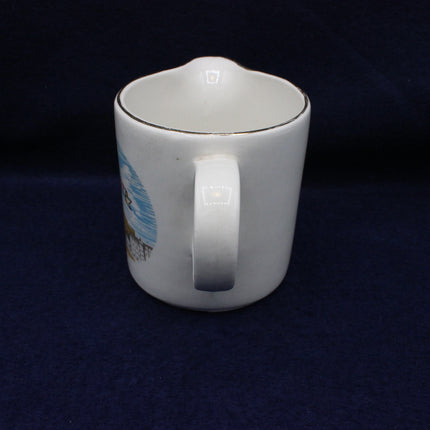 White ceramic pitcher with a handle on a dark background