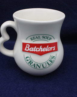 White mug with Batchelors soup granules branding on a dark blue background