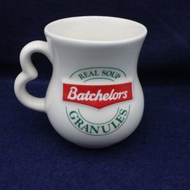 White mug with Batchelors soup granules branding on a dark blue background