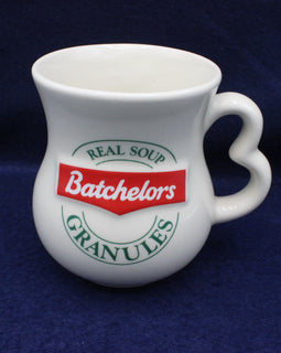 White mug with Batchelors soup granules branding on a dark blue background