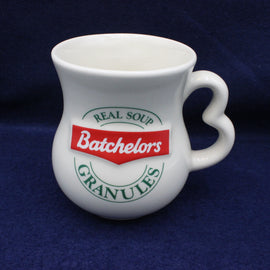 White mug with Batchelors soup granules branding on a dark blue background