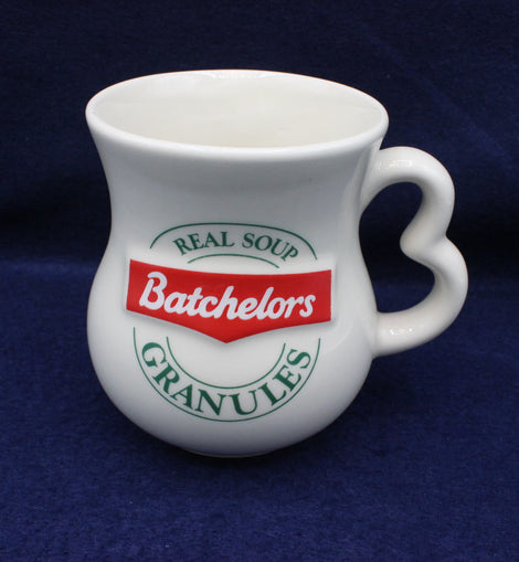 White mug with Batchelors soup granules branding on a dark blue background