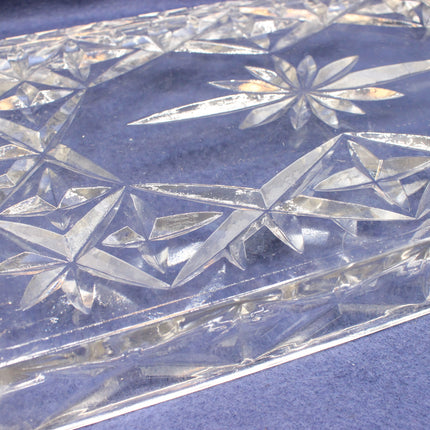 Close-up of a crystal dish with geometric patterns on a blue background