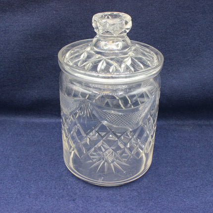Clear glass jar with a lid on a blue background