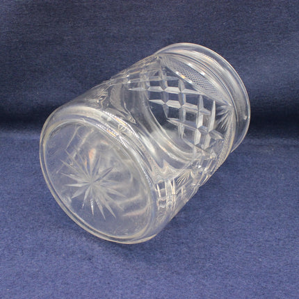 Clear glass with intricate cut patterns on a blue background