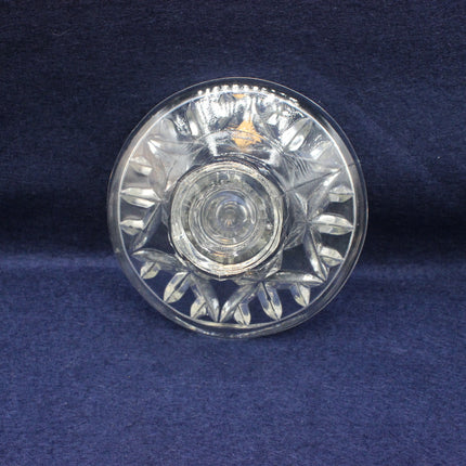 Clear glass dish with floral patterns on a blue background