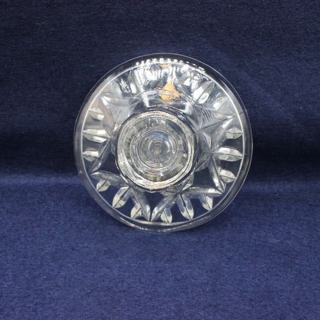 Clear glass dish with floral patterns on a blue background