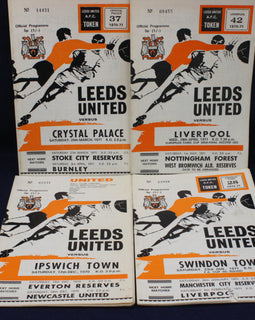 Collection of Leeds United football match programs from various matches on a dark background