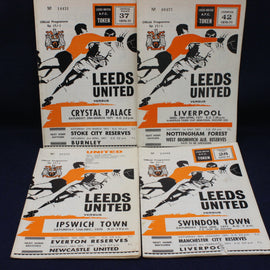 Collection of Leeds United football match programs from various matches on a dark background