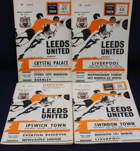 Collection of Leeds United football match programs from various matches on a dark background