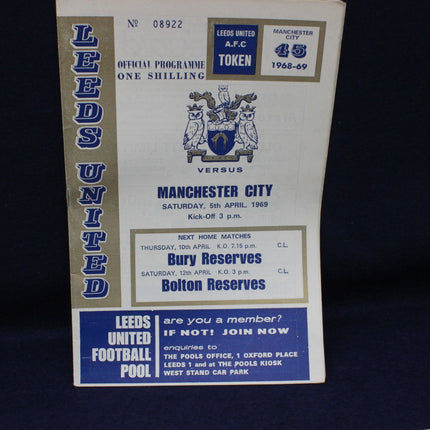Vintage Leeds United vs Manchester City football programme on a dark background