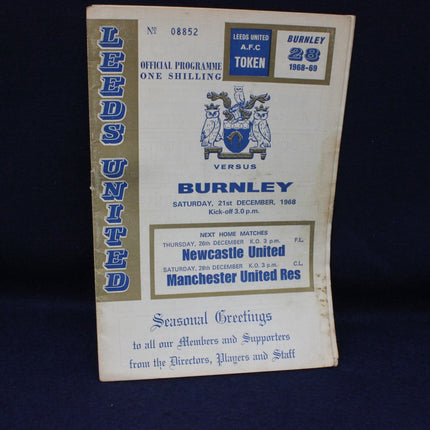 Vintage Leeds United vs Burnley football program on a dark background