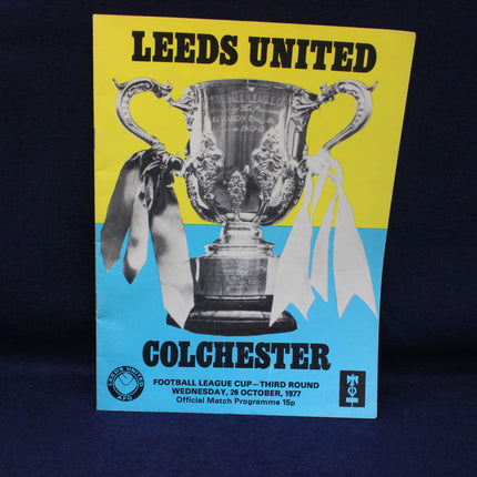 Leeds United vs Colchester match program with a trophy on a yellow and blue background