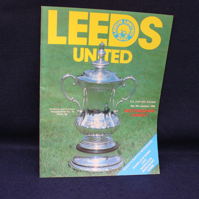 Leeds United football club programme with a silver trophy on a green background
